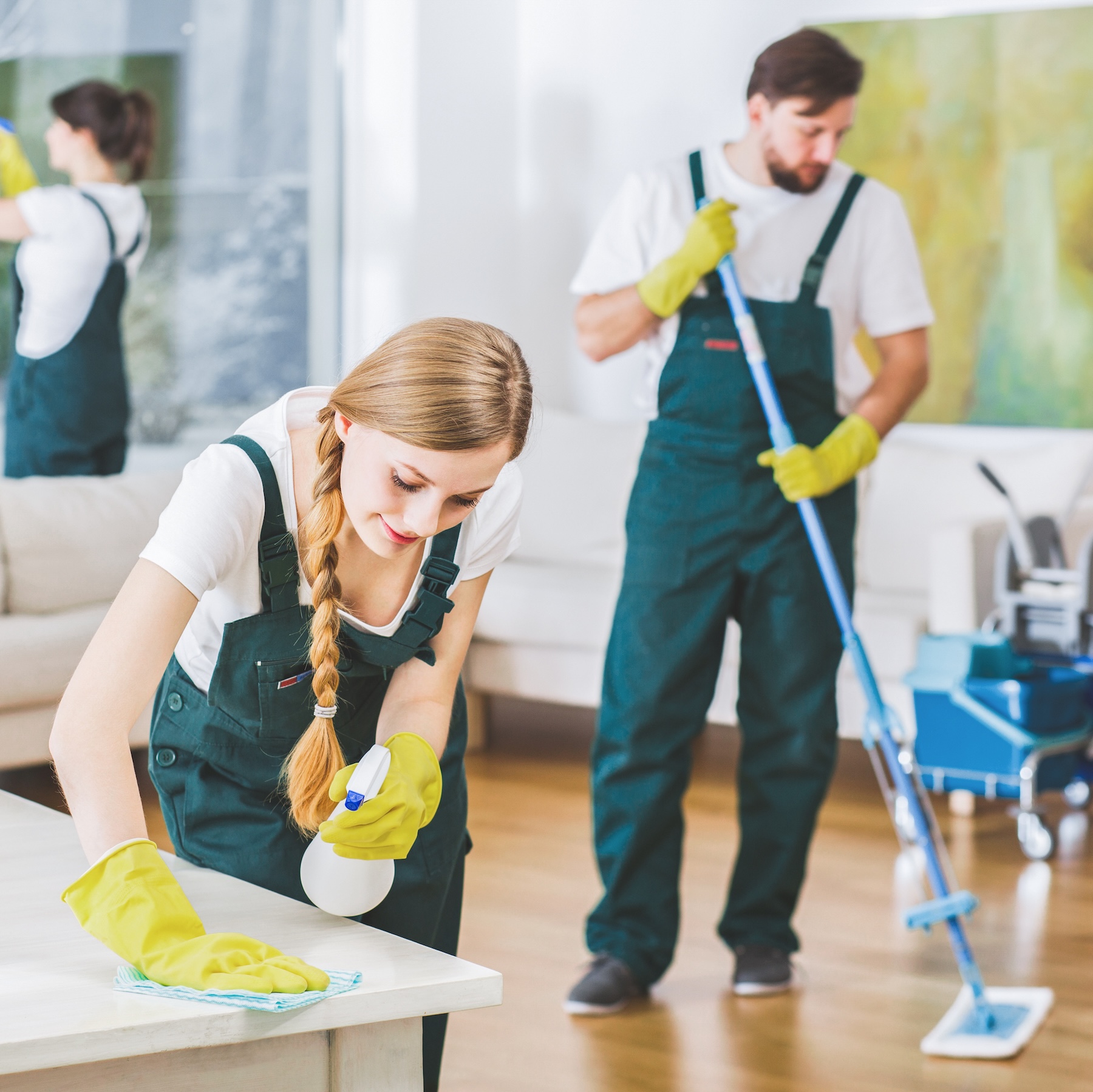Cleaning service employees with professional equipment cleaning a private home after renovation