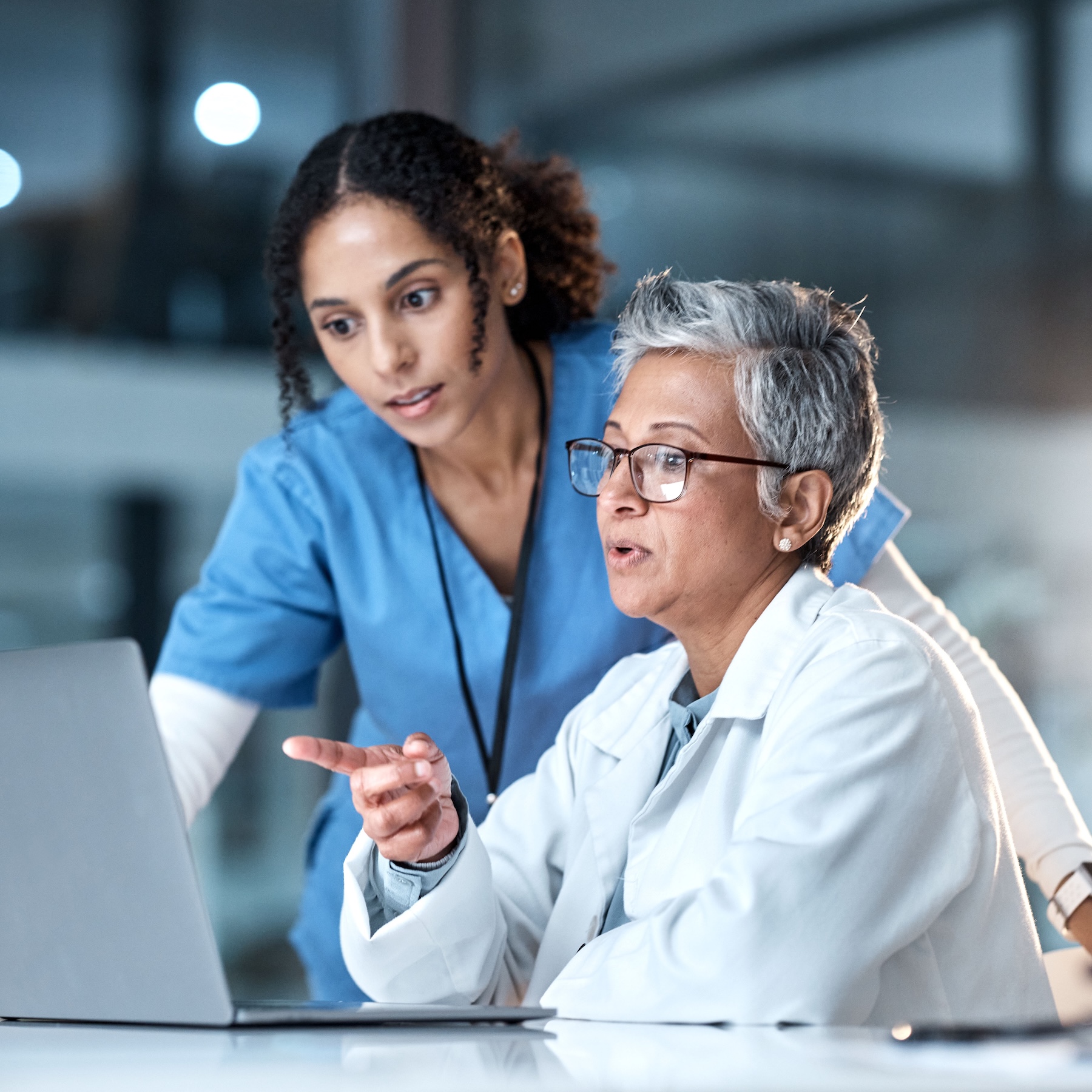 Doctor and nurse looking at laptop together